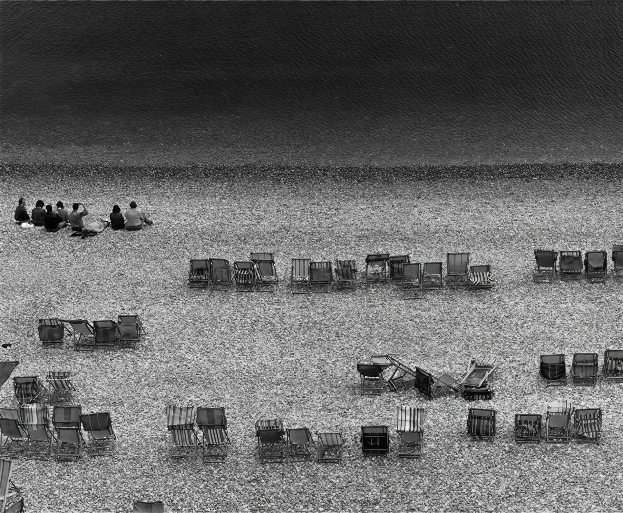 Group on rocky beach with chairs